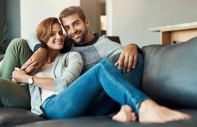 Photo couple portrait and relax on couch at home for comfort love and bonding time together with trust and care man woman and happy in living room for connection peace or support on weekend with smile