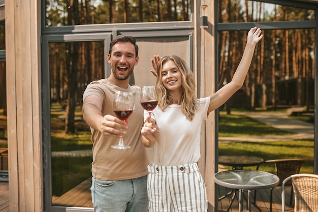 Couple posing for the camera with alcoholic beverages