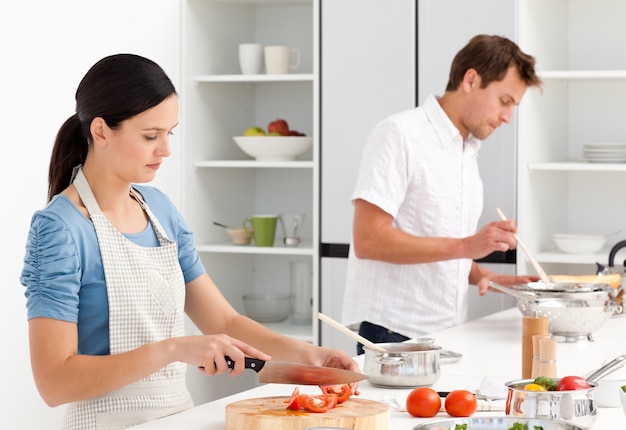 Couple preparing bolognese sauce and pasta together