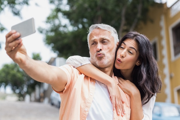 Couple puckering lips while taking selfie