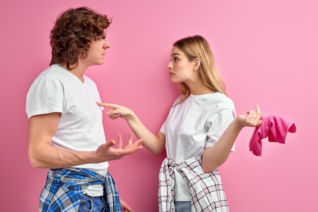 couple quarrel due to household chores. woman is unhappy with inaction of her husband during the cleaning at home