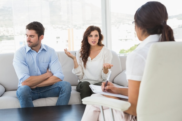 Couple quarreling in front of their therapist  