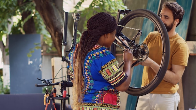 Couple repairing bicycle with tools