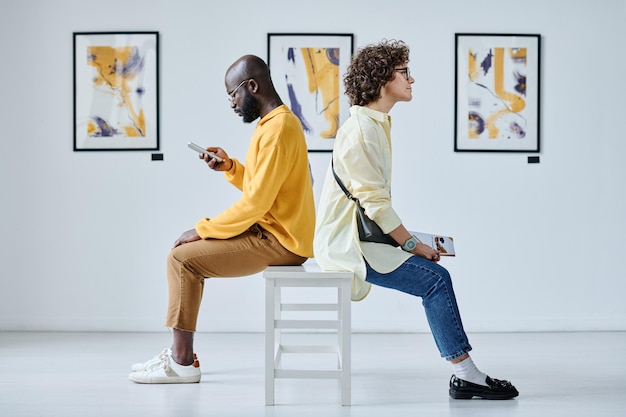 Couple resting after excursion at gallery