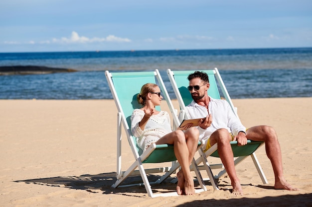 Couple resting together on the beach