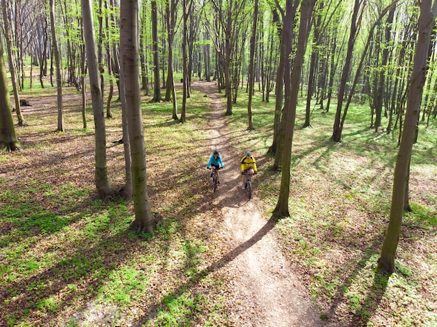 couple riding bicycles in the forest healthy lifestyle