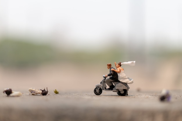 Couple riding the motorcycle in the garden