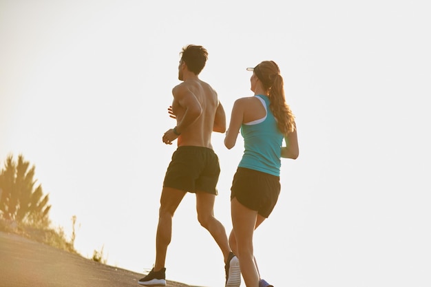 Photo couple running and workout on mountain street race and cardio challenge or marathon training people action and bonding together on morning jog back and sports performance in outdoor nature