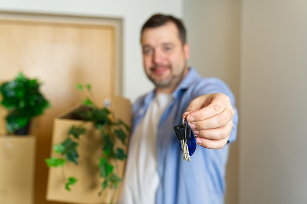 Couple showing keys to new apartment real estate mortgage loan concept moving in new house