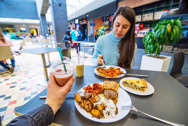 Couple sit in mall cafe and having dinner. lifestyle. date in cafe