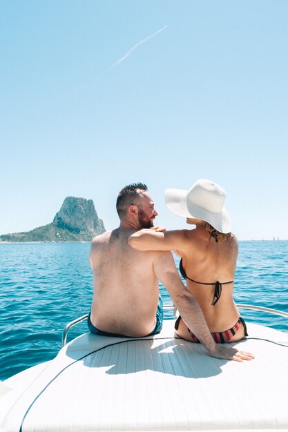 Couple sitting on boat deck enjoying the view at the mediterranean sea