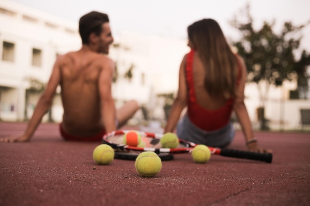 Couple sitting on the floor after playing tennis - Natural Sunset Light