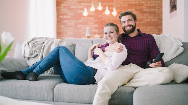 Couple sitting and watching TV together