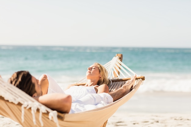 Couple sleeping in hammock