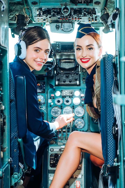 Couple Smiling female pilots in the aircraft Portrait of smiling female pilots Looking at camera in