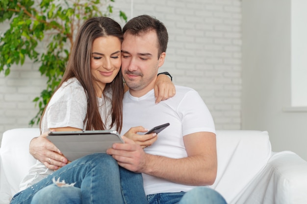 Couple on sofa with digital tablet