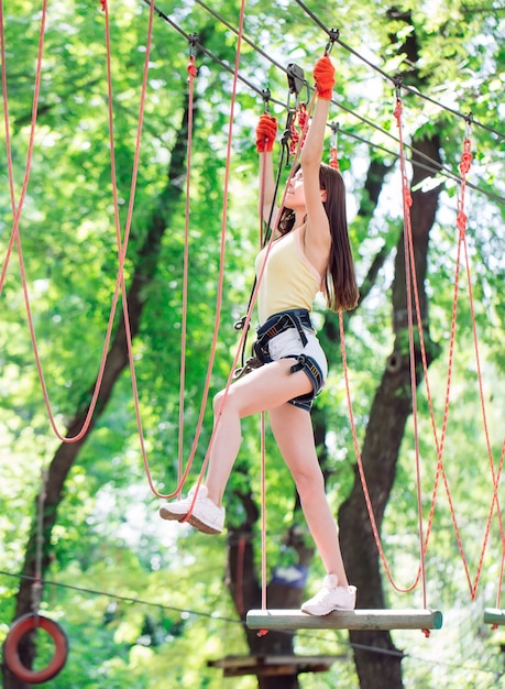 Couple spend their leisure time in a ropes course. man and woman engaged in rock-climbing,