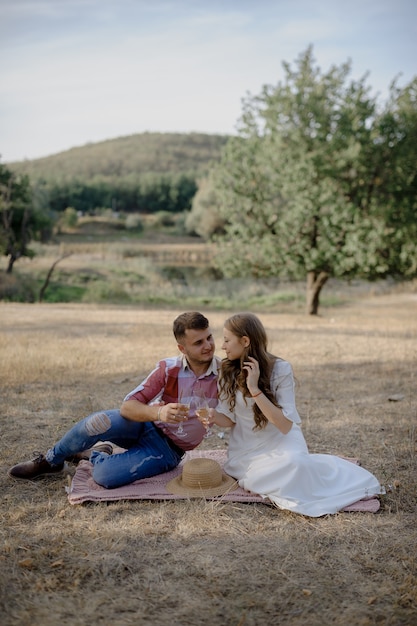 Couple spending time in a park, outdoors at a picnic.