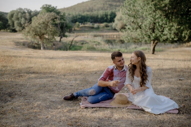 Couple spending time in a park, outdoors at a picnic.