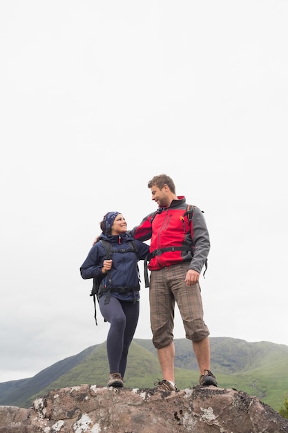 Couple standing on a rock embracing 