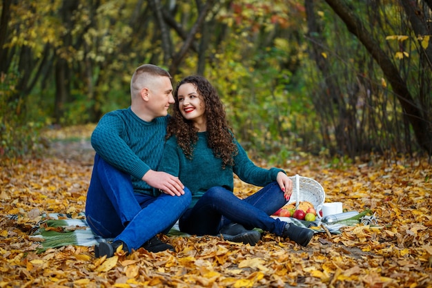 Couple in sweaters in the autumn park