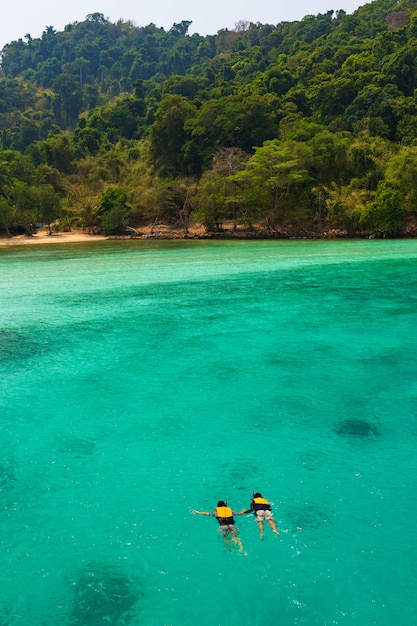 Couple swim in sea