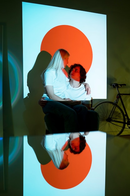 Couple taking photos in the light of movie projector