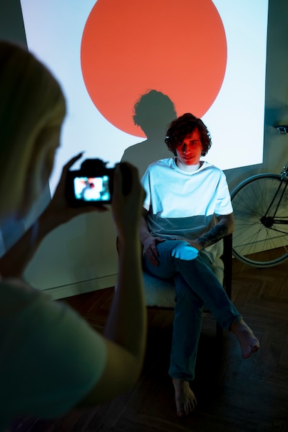 Couple taking photos in the light of movie projector