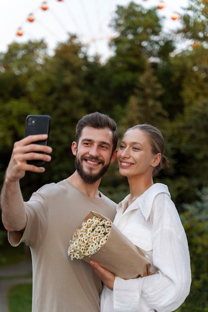 Couple taking selfie while out together at the ferris wheel