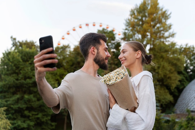 Couple taking selfie while out together at the ferris wheel