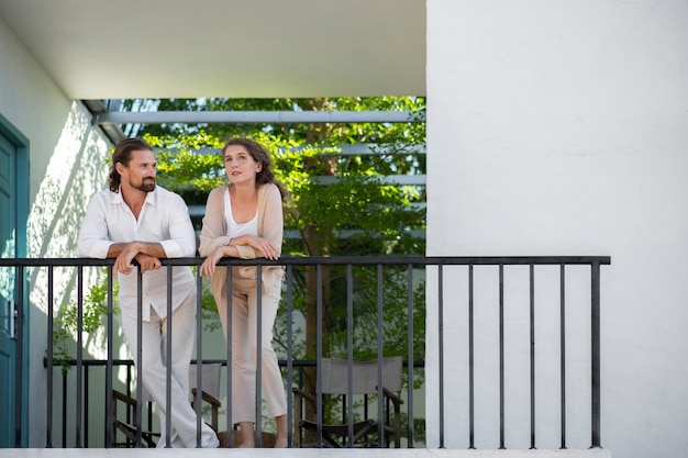 Couple talking on the balcony during vacation