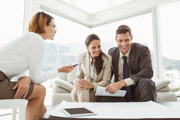 Couple talking to female architect