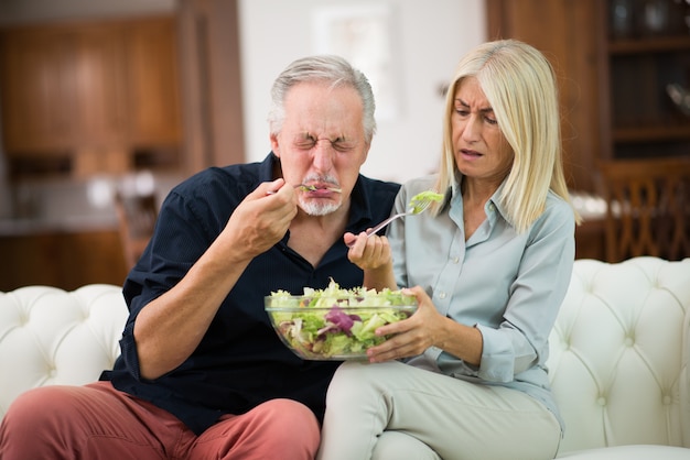 Couple tasting a flavorless salad