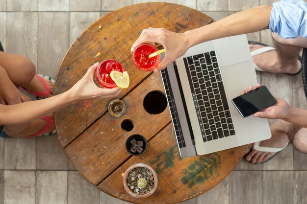 Couple toasting while working on summer vacation