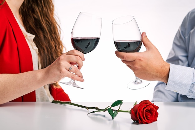 Couple toasting with a glass of wine together. Concept of Valentine's Day and couple in love.