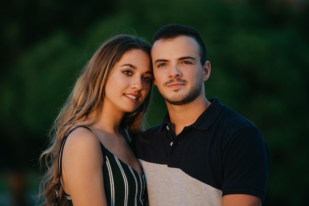 A couple of tourists are having fun with green bushes in the background