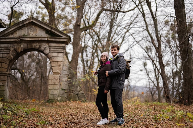 Couple tourists near ruins arch of Pidhirtsi Castle Lviv region Ukraine