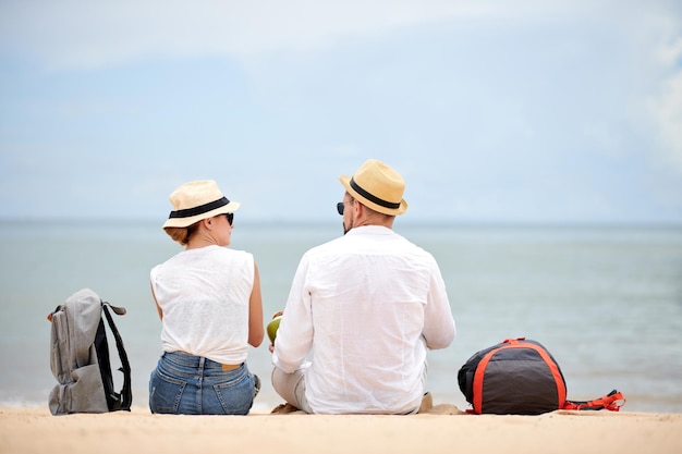 Couple of tourists sitting on beach