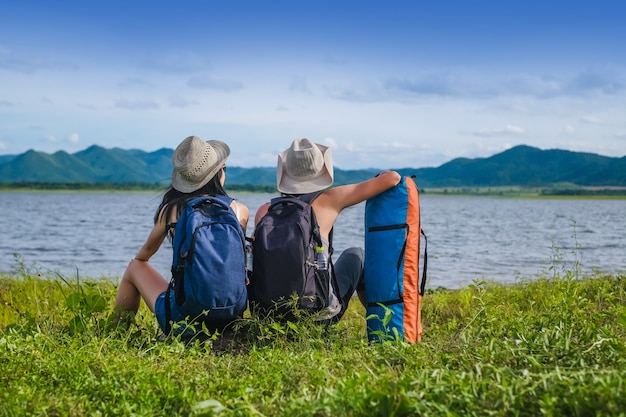 couple traveler sitting near the lake  in the mountain