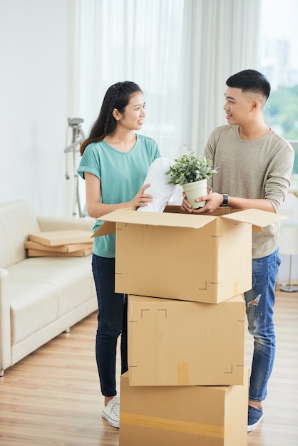 Couple unpacking things from box