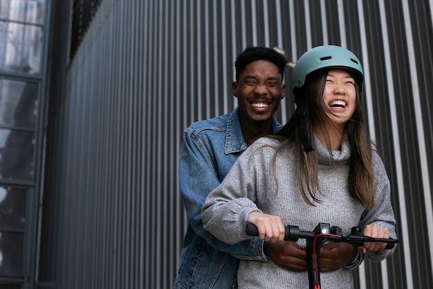 Couple using electric scooter for transportation