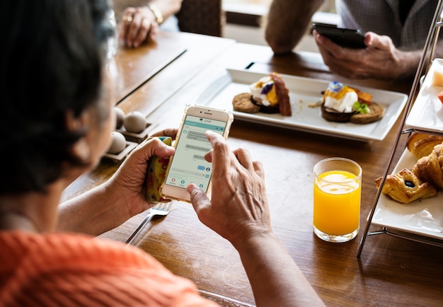 Couple using their smartphones at dinner