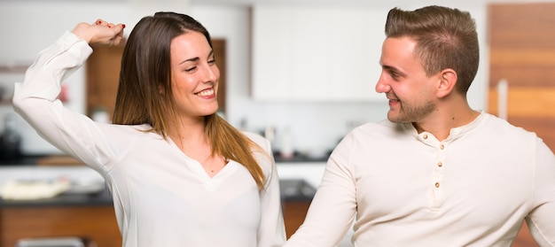 Couple in valentine day enjoy dancing while listening to music at a party in a house