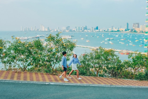 Couple at the view point on the island of Pattaya sea At the park of Pattaya in Thailand in summer city with blue sky for travel background Chonburi skyline