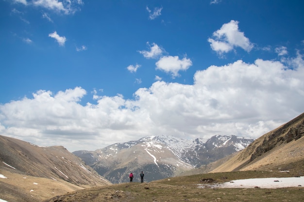 Couple walking in the distance during spring in the Catalan Pyrenees