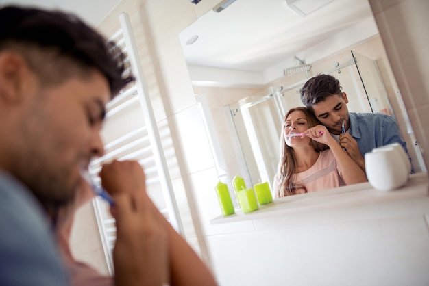 Couple washing their teeth