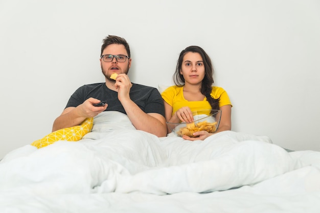 Couple watchin boring movie in bed