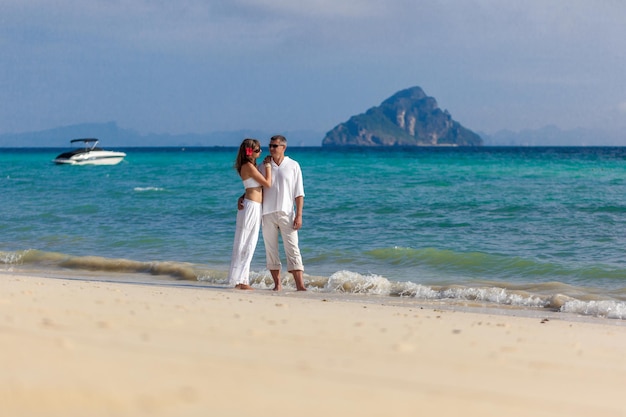 Couple in white on the beach