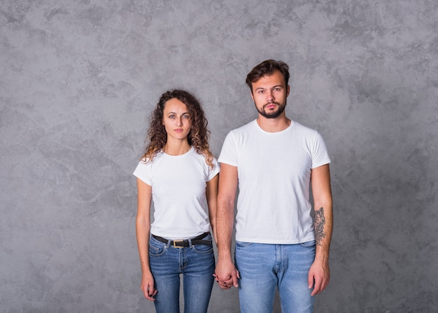 Couple in white holding hands 