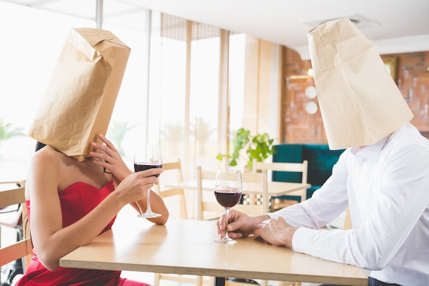 Couple with brown paper bags over their heads